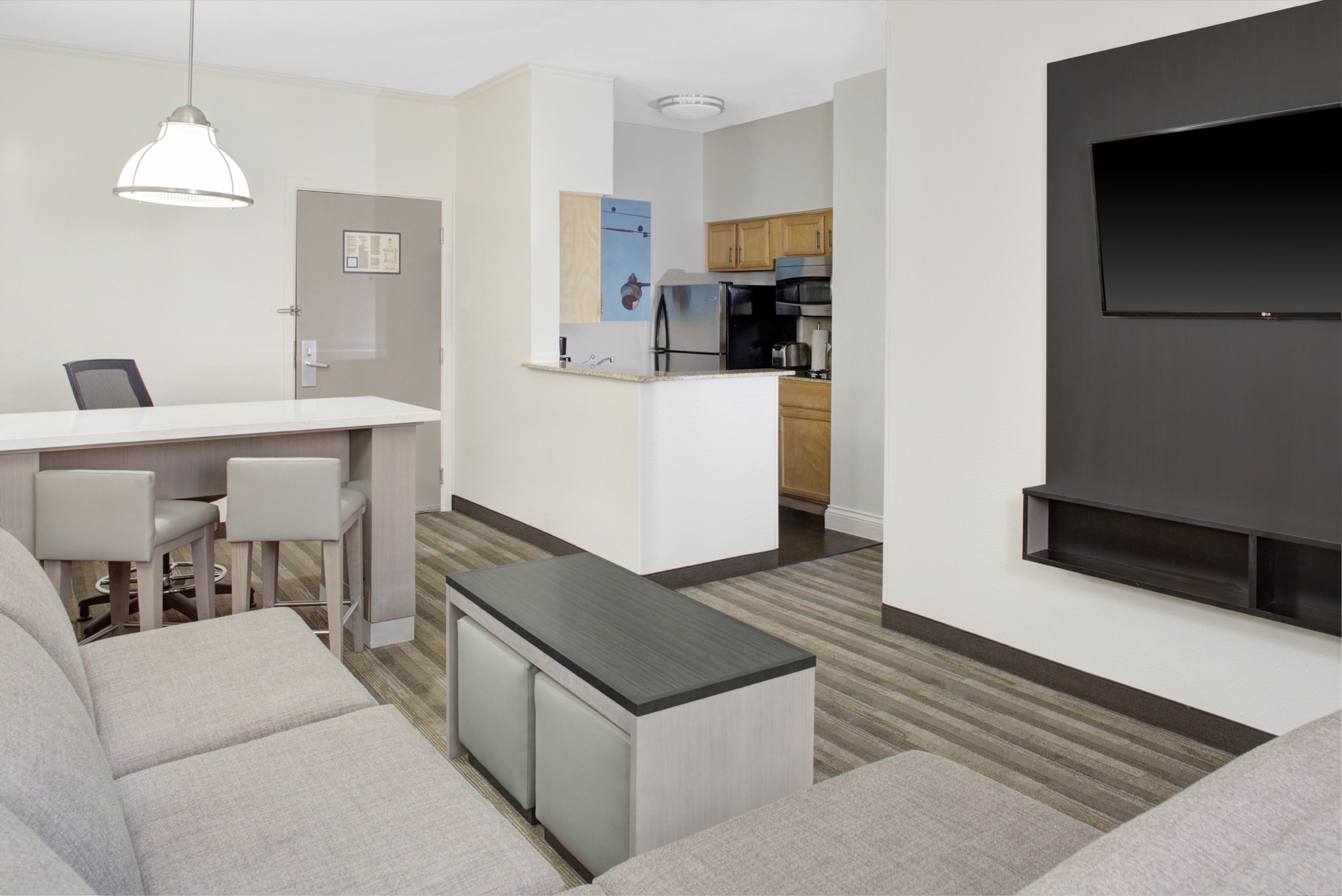 Hyatt House all-suite guestroom with full kitchen and living area